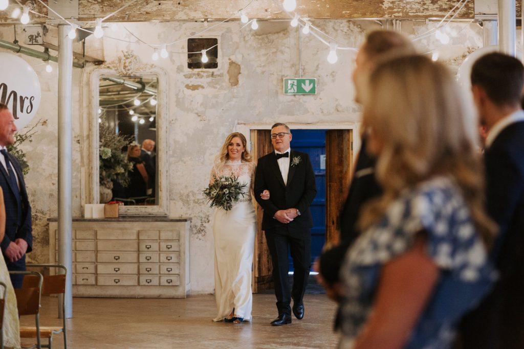 bride and dad walking down aisle
