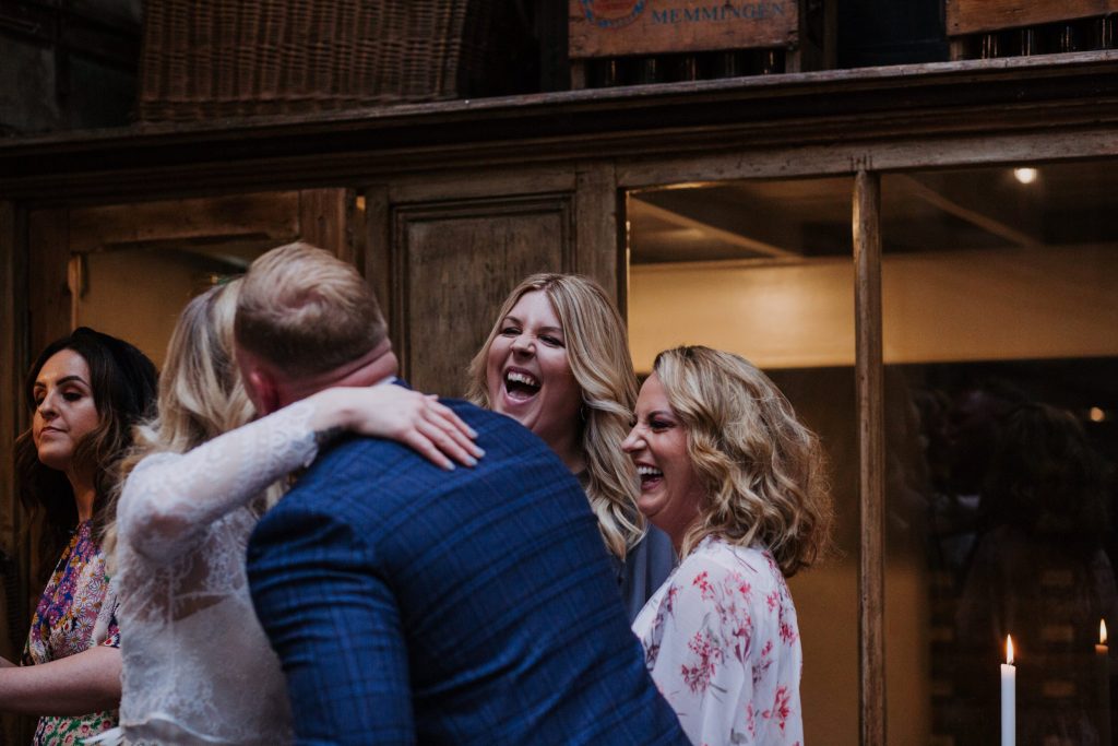 laughing wedding guests