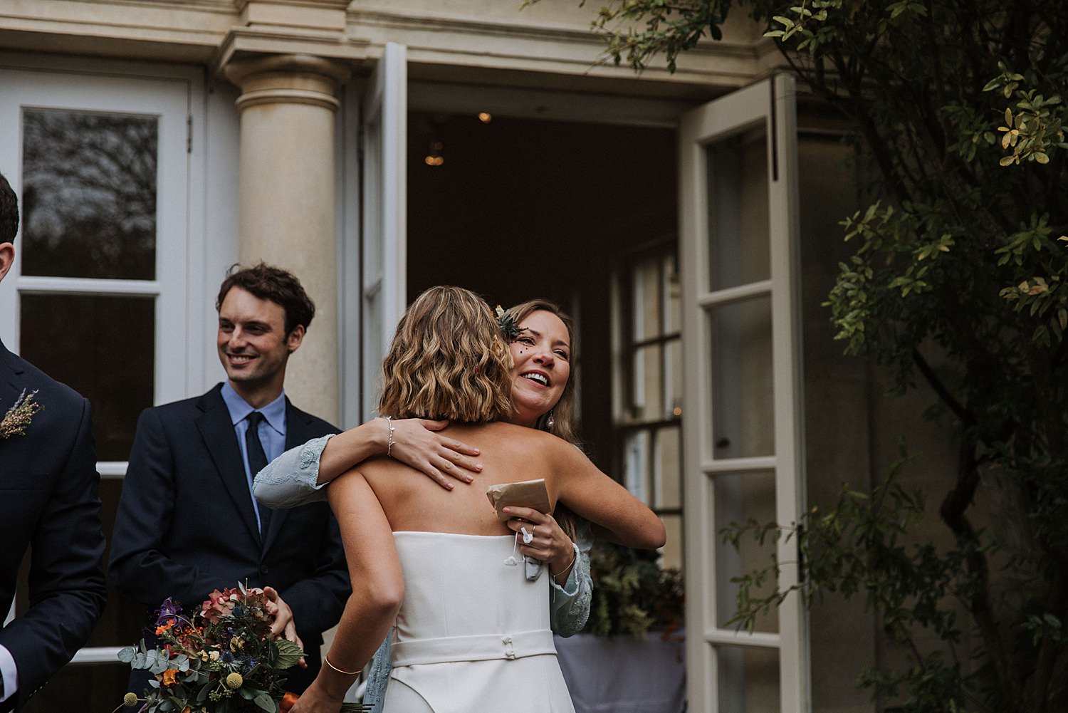 guest hugging bride